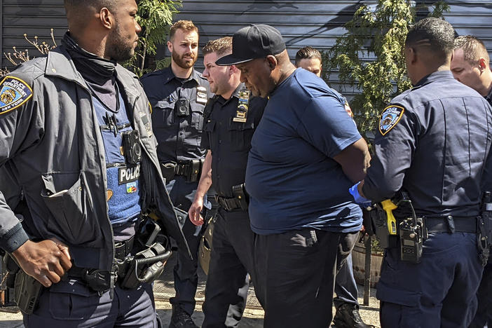 New York City Police Department officers handcuff subway shooting suspect Frank R. James, 62, in the East Village section, of New York, Wednesday, April 13, 2022.