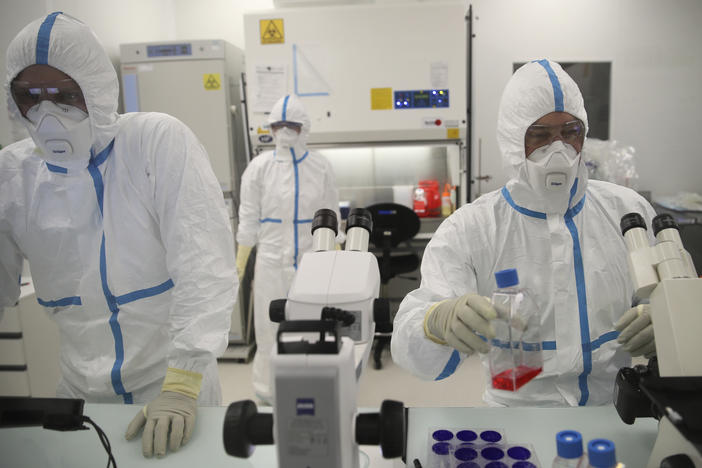 Laboratory technicians work at the Valneva headquarters in Saint-Herblain, western France, Wednesday, Feb.3, 2021.