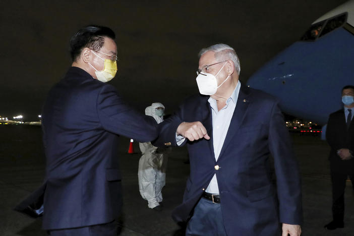 In this photo released by Taiwan's Ministry of Foreign Affairs, Taiwan's Foreign Minister Joseph Wu, left, greets Sen. Bob Menendez, D-N.J., as he arrives in Taipei, Taiwan, Thursday, April 14, 2022.
