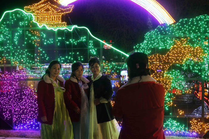 Citizens take a photo at a light festival in celebration of 110th birth anniversary of their late leader Kim Il Sung at Kim Il Sung Square in Pyongyang, North Korea Thursday, April 14, 2022.