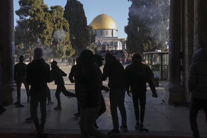 Palestinians clash with Israeli security forces at the Al Aqsa Mosque compound in Jerusalem's Old City Friday, April 15, 2022.