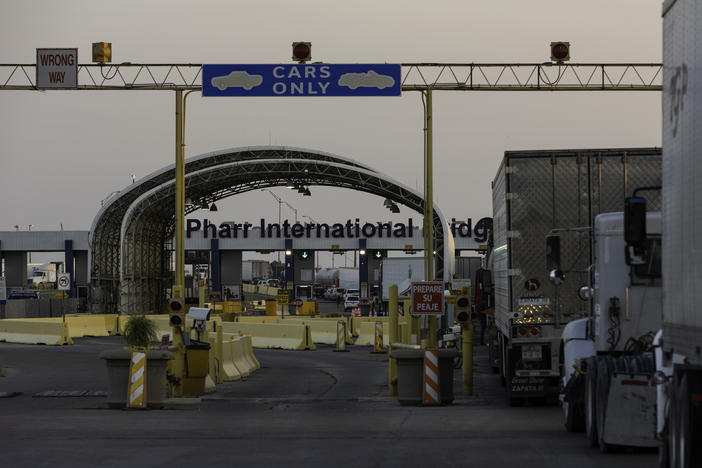 Several dozen commercial trucks wait to cross the Pharr-Reynosa International bridge on April 13 in Pharr, Texas.