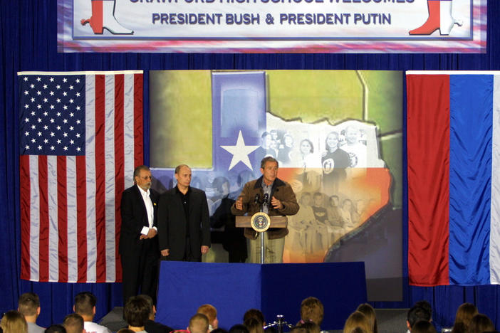 President George W. Bush and Russian President Vladimir Putin speak during a visit to Crawford High School in Crawford, Texas, on Nov. 15, 2001. The appearance wrapped up a summit of the newly elected presidents in Texas.