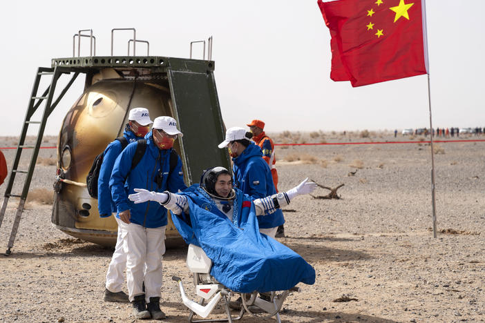 Chinese astronaut Ye Guangfu sits outside the return capsule of the Shenzhou-13 space mission after landing at the Dongfeng landing site in northern China's Inner Mongolia Autonomous Region on Saturday.