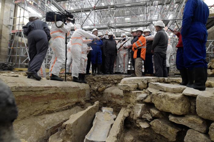 France's Culture Minister Roselyne Bachelot (center left) visits the Notre Dame Cathedral archaeological research site in Paris on March 15 after the discovery of a 14th century lead sarcophagus.