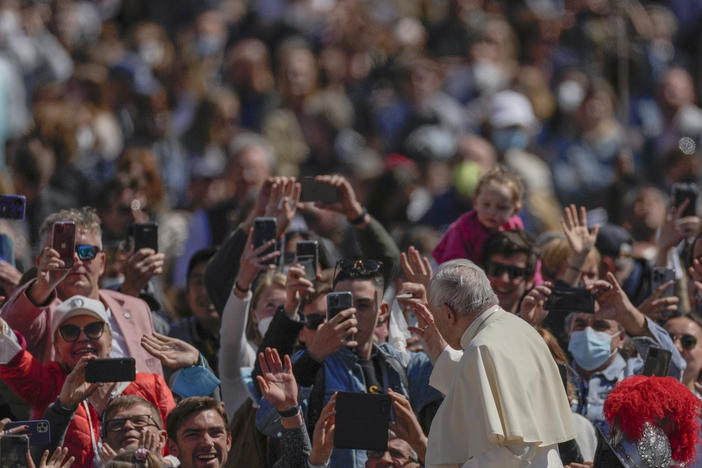 Pope Francis on his popemobile drives through the crowd of faithful at the end of the Catholic Easter Sunday mass he led in St. Peter's Square at the Vatican, Sunday, April 17, 2022.