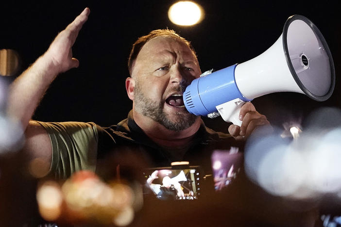 Infowars host and conspiracy theorist Alex Jones rallies pro-Trump supporters outside the Maricopa County Recorder's Office, on Nov. 5, 2020, in Phoenix.