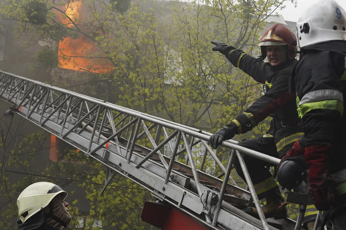 Firefighters work to extinguish fire at an apartment building after a Russian attack in Kharkiv, Ukraine, Sunday, April 17, 2022.