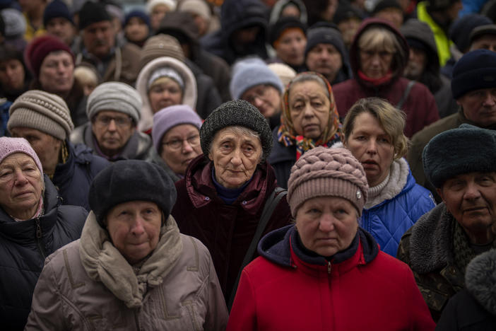 <strong>April 18:</strong> Ukrainians wait as Red Cross relief workers distribute food in Bucha, on the outskirts of Kyiv, Ukraine.