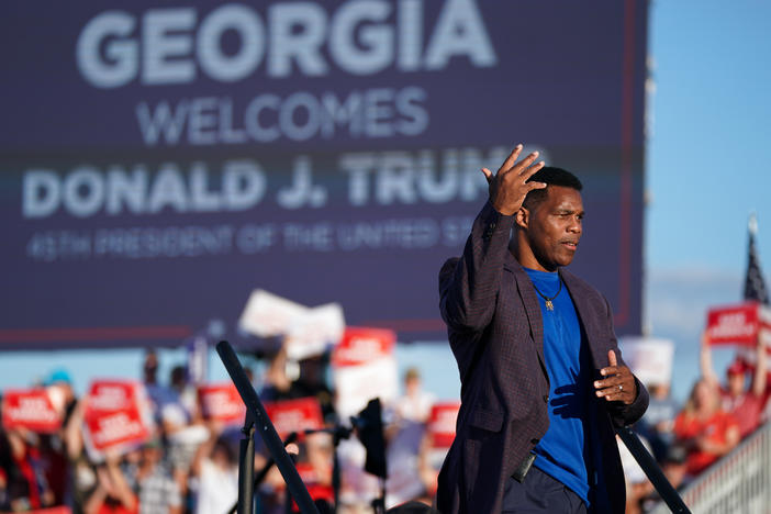 Republican Senate candidate Herschel Walker walks off the stage during a rally featuring former President Donald Trump on Sept. 25 in Perry, Georgia.