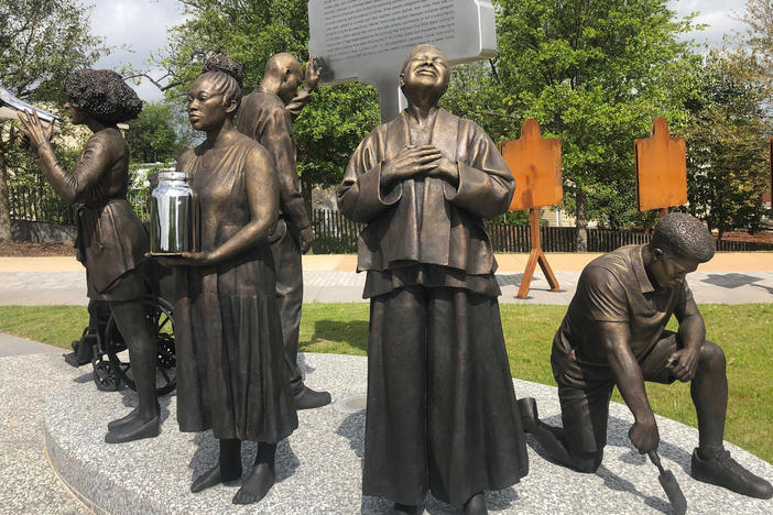 Artist Branly Cadet's <em>Arise</em> sculpture at the National Memorial for Peace and Justice in Montgomery, Ala.,<em> </em>portrays community activists.