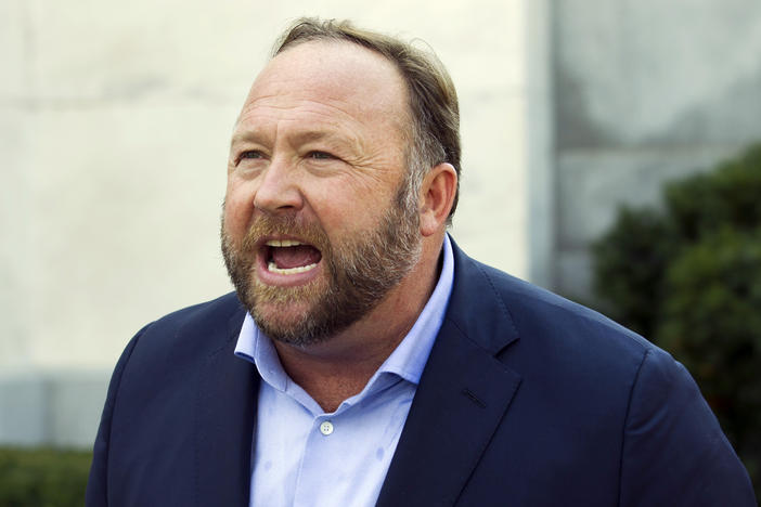 Infowars host and conspiracy theorist Alex Jones speaks in Washington, D.C., on Sept. 5, 2018. A Texas judge on Wednesday pushed back a trial over how much Jones should pay the families of Sandy Hook victims.