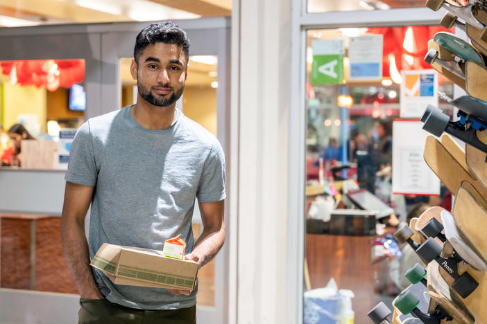 Talha Rafique picks up his to-go suhoor box from a campus dining hall at the University of Southern California. "My friends and I actually look forward to Ramadan," he says.