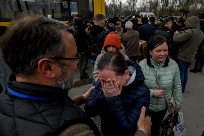 People fleeing the Ukrainian city of Mariupol arrive at a registration center for internally displaced people in Zaporizhzhia on Thursday. They traveled in a small convoy that crossed through territory held by Russian forces, after the opening of a humanitarian corridor.