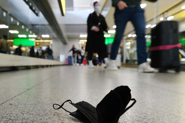 A mask is seen on the ground at John F. Kennedy Airport in New York City. On Monday, a federal judge in Florida struck down the mask mandate for airports and other methods of public transportation as a new COVID variant is on the rise across parts of the United States.