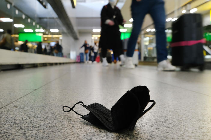 A discarded mask is seen on the floor inside New York's John F. Kennedy Airport on Tuesday, a day after a federal judge in Florida struck down the CDC's mask mandate for public transportation.