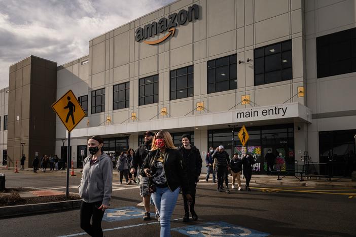 Workers walk to cast their votes over whether or not to unionize, at an Amazon warehouse on Staten Island on March 25, 2022. Another Amazon warehouse across the street began voting on a union on Monday.