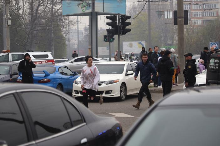 People leave a residential area after Russian shelling struck the Ukrainian city of Odesa on Saturday. At least six people were killed, according to Ukrainian officials.