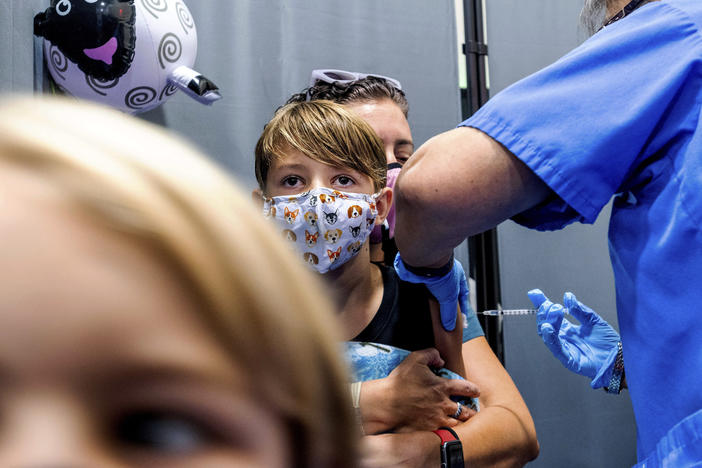 Finn Washburn, 9, receives an injection of the Pfizer-BioNTech COVID-19 vaccine in San Jose, Calif., in November. Now the pharmaceutical companies are seeking authorization to give kids a booster dose of the vaccine.