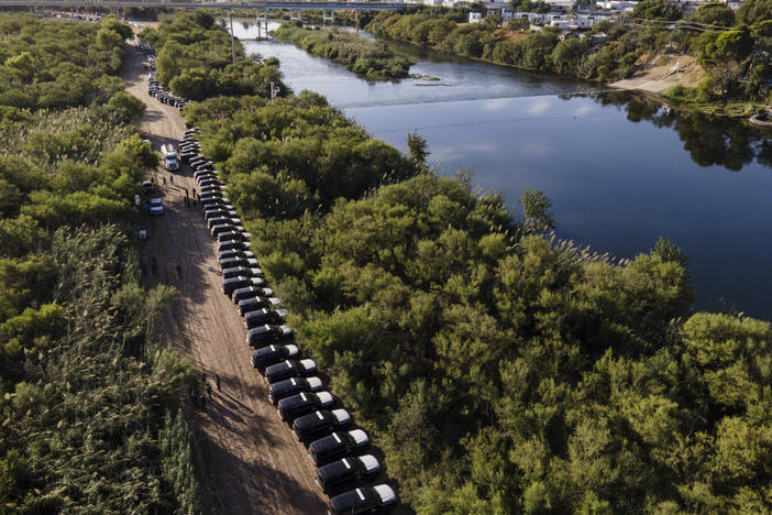 A line of Texas Department of Safety vehicles line up on the Texas side of the Rio Grande. Texas Gov. Greg Abbott launched Operation Lone Star last year to crack down on unauthorized border crossings into the U.S.