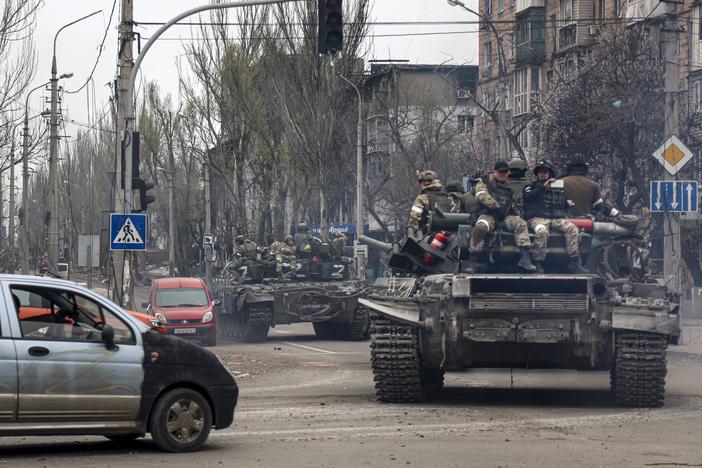 Russian tanks roll along a street in an area controlled by Russian-backed separatist forces in Mariupol, Ukraine, on April 23, 2022.