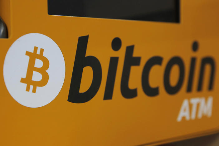 A Bitcoin logo is displayed on an ATM in Hong Kong in 2017. More workers may soon be able to stake some of their 401(k) retirement savings to bitcoin.