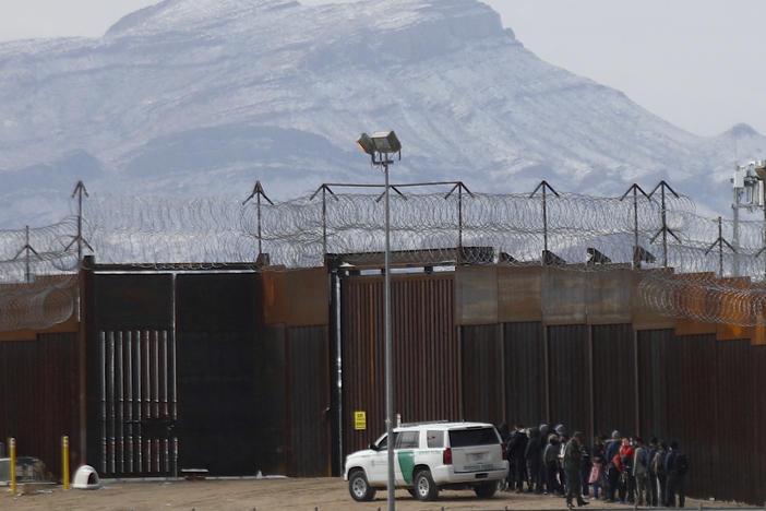 Border Patrol agents detain a group of migrants in El Paso, Texas, near the border wall after they entered the U.S. from Ciudad Juarez, Mexico, in February.