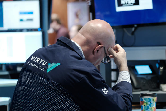 Traders work on the floor of the New York Stock Exchange (NYSE) in New York City on Monday. Stocks continued a recent sell-off over economic and earnings fears.