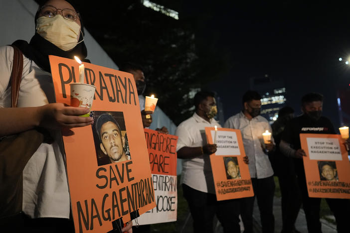 Activists holds posters against the impending execution of Nagaenthran K. Dharmalingam, sentenced to death for trafficking heroin into Singapore, during a candlelight vigil gathering outside the Singaporean Embassy in Kuala Lumpur, Malaysia, Tuesday, April 26, 2022.