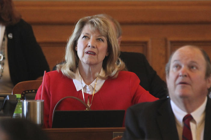 Kansas state Rep. Cheryl Helmer (center), R-Mulvane, watches one of the House's electronic tally board during vote on April 26 at the Statehouse in Topeka, Kan. Helmer has complained publicly about having to share women's restrooms with a transgender colleague.