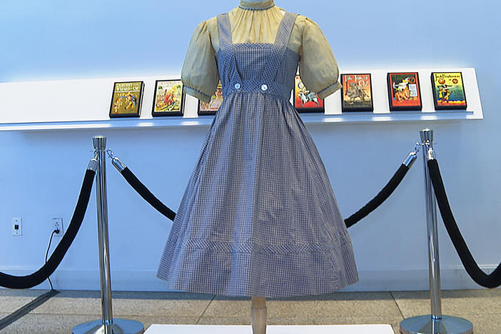A blue and white checked gingham dress, worn by Judy Garland in <em>The Wizard of Oz,</em> hangs on display, Monday, April 25, 2022, at Bonhams in New York.