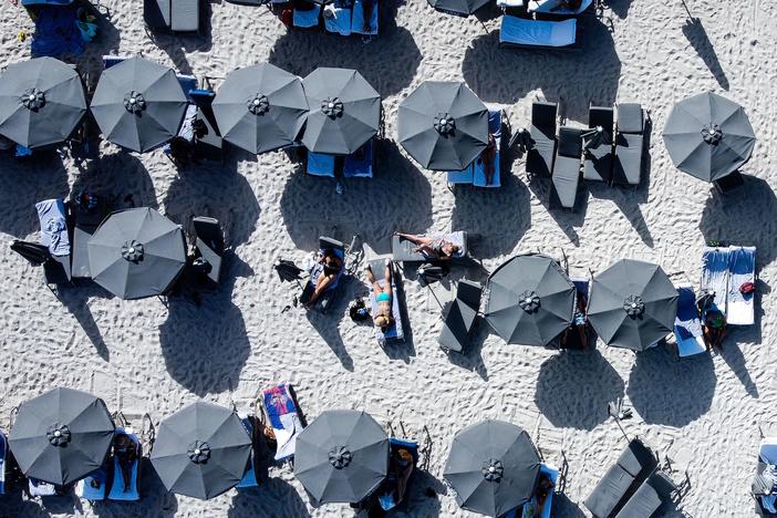 The U.S. economy likely slowed sharply in this year's first quarter, but conditions may be sturdier than they look as consumer spending remains healthy. Here, people relax in Sunny Isles Beach, Fla., on March 8.