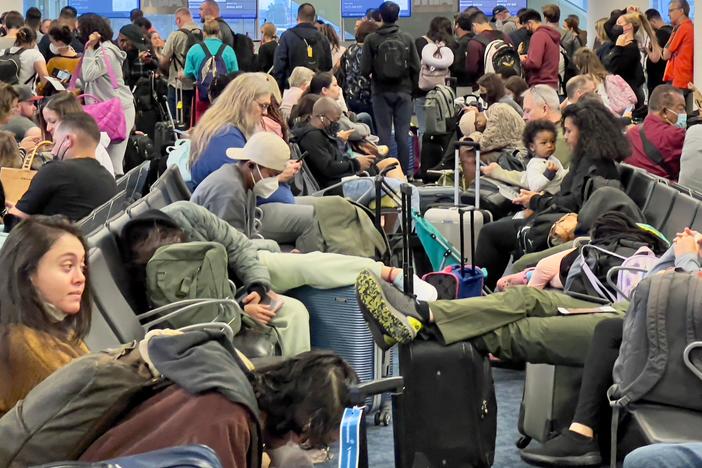 Dr. Anthony Fauci, chief medical adviser to President Biden, cites the U.S. vaccination program and previous widespread transmission of the coronavirus as reasons why the U.S. is not now under pandemic conditions. Here, travelers wait at Miami International Airport last week after mask requirements were lifted.