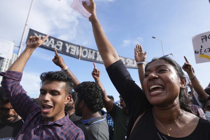 People shout slogans against the government during an ongoing protest outside president's office in Colombo, Sri Lanka, Saturday, April 23, 2022.