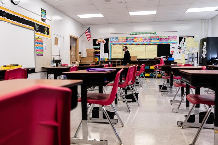 A teacher walks through an empty classroom at Hazelwood Elementary School in Louisville, Ky., on Jan. 11.