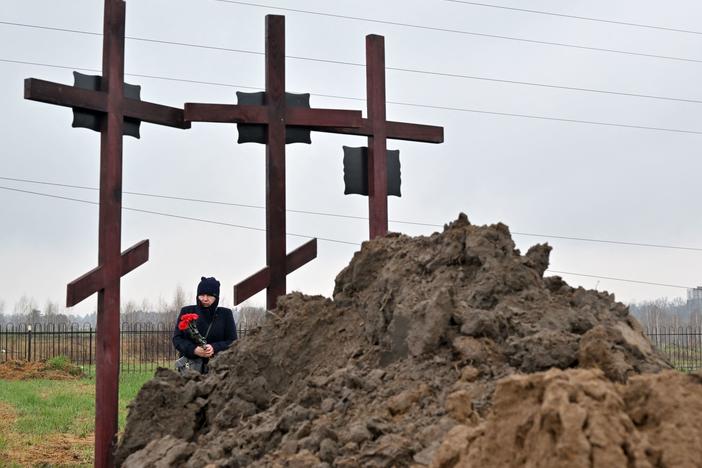 A mourner attends the funeral of a family of three in Bucha, on the outskirts of Kyiv, on Friday.