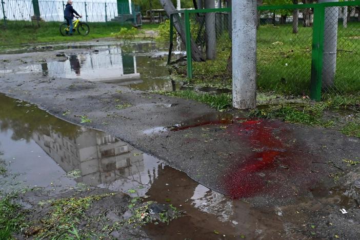 Blood is seen on a sidewalk in a residential area following shelling in Kharkiv, eastern Ukraine, on Wednesday.