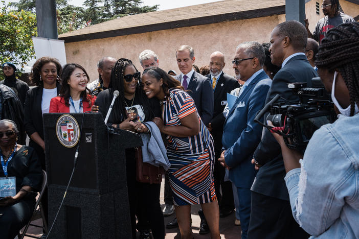 Shinese Harlins-Kilgore, cousin of Latasha Harlins and CEO of the Latasha Harlins Foundation, receives a hug from Lora King, daughter of Rodney King and CEO of the Rodney King Foundation, during the 30th anniversary of the Rodney King Civil Unrest HOPE Community Bus Tour Press conference in Los Angeles. Latasha, 15, was fatally shot in a liquor store.