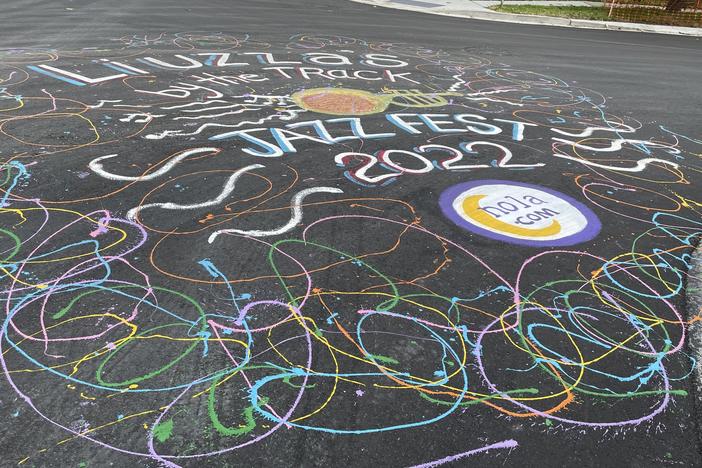 A freshly painted street mural outside Liuzza's by the Track in New Orleans on Tuesday, April 26, 2022, celebrates the impending return of the New Orleans Jazz and Heritage Festival.