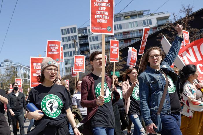 Protesters march in Seattle during the "Fight Starbucks' Union Busting" rally and march on April 23, 2022.