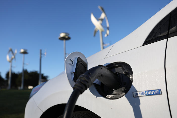 An electric vehicle gets its battery recharged at a charge station in San Francisco on March 9. The Biden administration is spending $5 billion to build a network of chargers in a bid to get more people to buy electric cars.