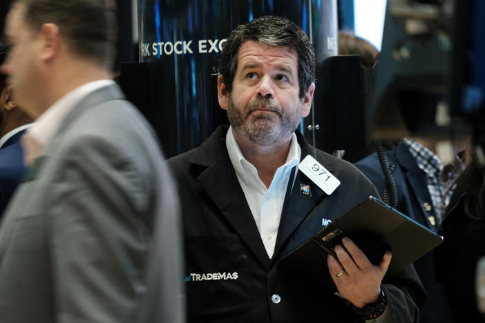 Traders work on the floor of the New York Stock Exchange (NYSE) in New York City on April 28. Stocks sank on Friday, ending a miserable month for Wall Street.