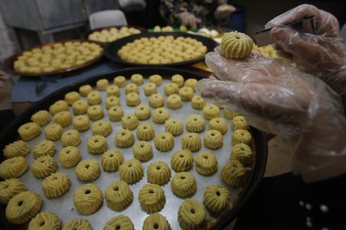 Palestinian women make traditional pastries filled with dates or nuts known as ma'amoul.