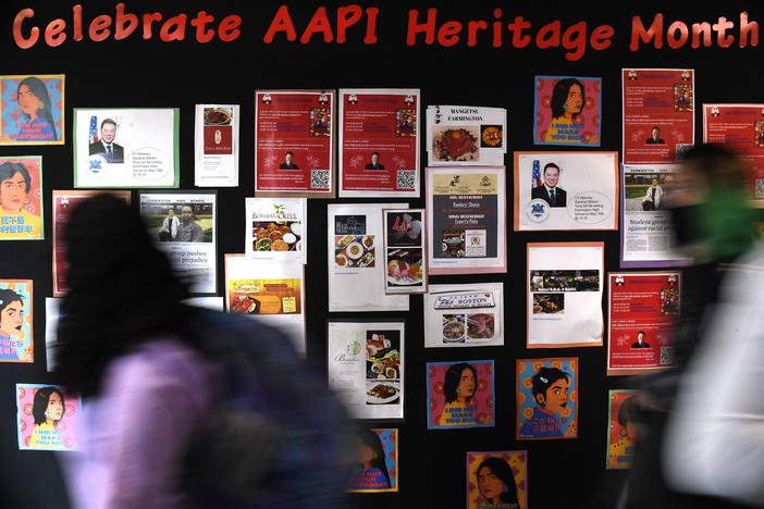 Students walk past a display for Asian Pacific American Heritage Month at Farmington High School in Farmington, Conn., on May 10, 2021