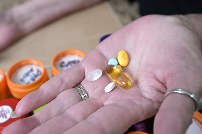 Retiree Donna Weiner shows some of the daily prescription medications for which she pays more than $6,000 per year through a Medicare prescription drug plan. She supports giving Medicare authority to negotiate drug prices.