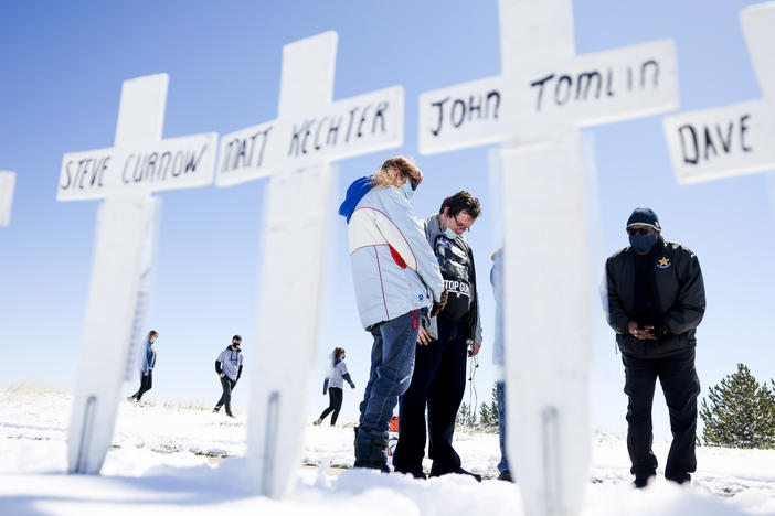 Mourners gather in Littleton, Colo., on April 20, 2021, to remember the victims of the 1999 Columbine High School shooting.