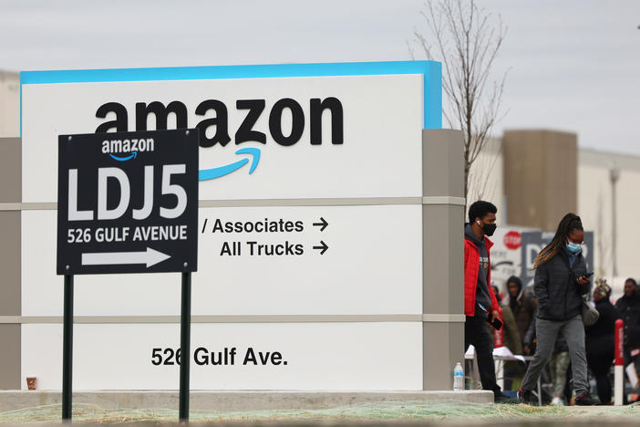 Workers walk toward an Amazon warehouse on Staten Island, New York, on April 25, 2022. It's the second Amazon facility on Staten Island to vote on whether to join the Amazon Labor Union.