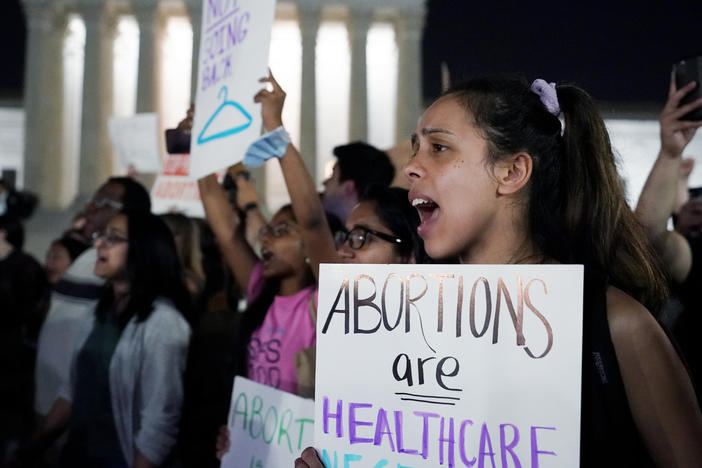 A crowd gathers outside the U.S. Supreme Court in Washington, D.C., early on Tuesday after a draft opinion was leaked indicating the court could strike down <em>Roe v. Wade</em>.