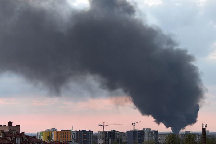 Dark smoke rises following an airstrike in the western Ukrainian city of Lviv, on Tuesday. Russia said its artillery hit hundreds of targets across the country in the past day.