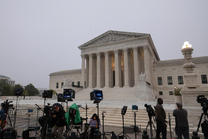 TV camera crews station in front of the Supreme Court building on Tuesday in Washington, D.C.